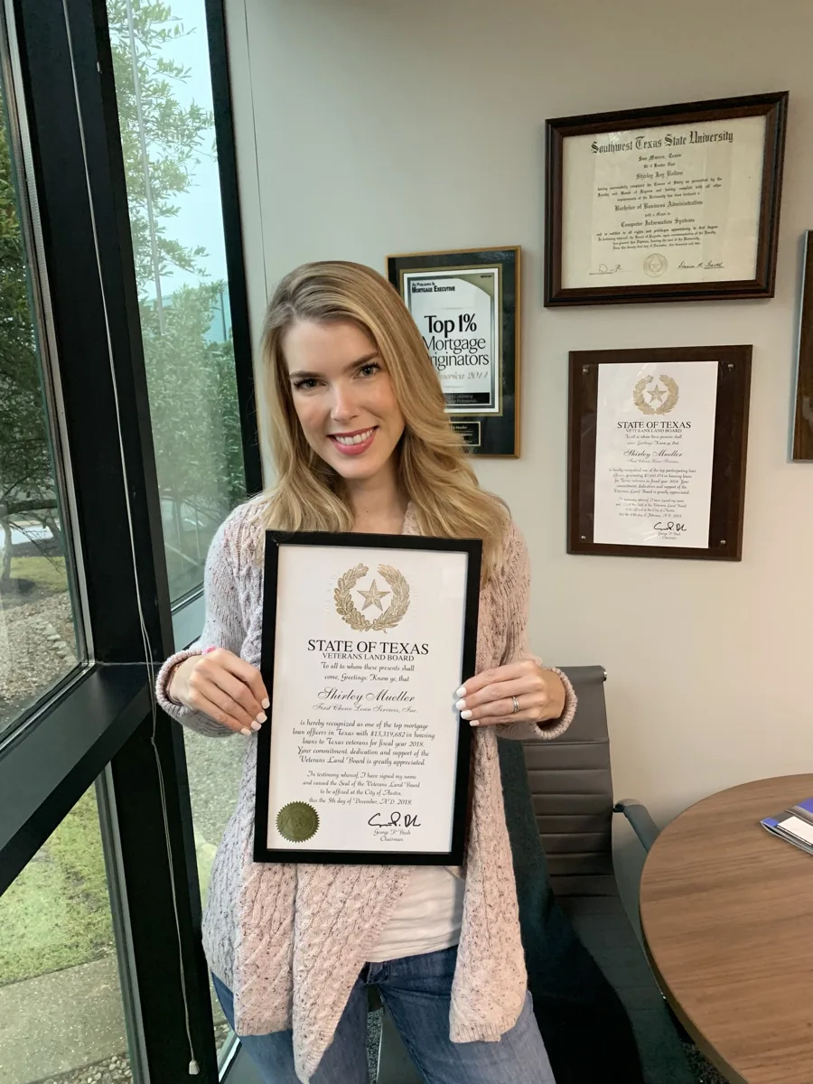 Shirley Mueller holding her Texas Veterans Land Board top loan officer award for fiscal year 2018